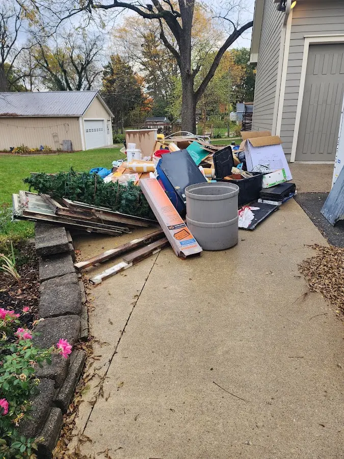 Dumpster being loaded with debris for 3 Yard Dumpster Rental in Oelwein